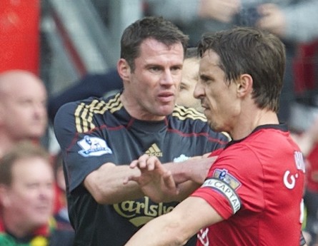 MANCHESTER, ENGLAND - Sunday, March 21, 2010: Liverpool's Jamie Carragher pushes aside Manchester United's argumentative Gary Neville during the Premiership match at Old Trafford. (Photo by: David Rawcliffe/Propaganda)