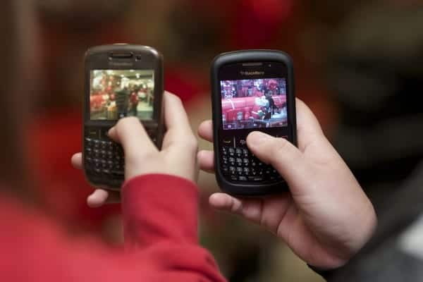 LIVERPOOL, ENGLAND - Friday, November 26, 2010: Liverpool supporters take photographs of Glen Johnson on their Blackberry mobile phones during a signing session for supporters at the Liverpool FC Club Shop at Anfield. (Photo by David Rawcliffe/Propaganda)