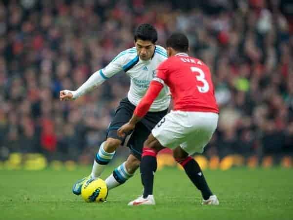 MANCHESTER, ENGLAND - Saturday, February 11, 2012: Liverpool's Luis Alberto Suarez Diaz takes on Manchester United's Patrice Evra during the Premiership match at Old Trafford. (Pic by David Rawcliffe/Propaganda)