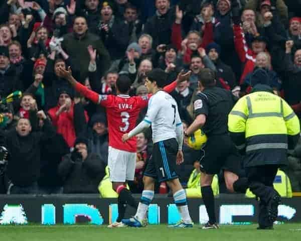 MANCHESTER, ENGLAND - Saturday, February 11, 2012: Unedifying scenes at the final whistle as Manchester United's Patrice Evra goes over the top to celebrates his side's 2-1 victory over Liverpool in the face of Luis Alberto Suarez Diaz during the Premiership match at Old Trafford. (Pic by David Rawcliffe/Propaganda)