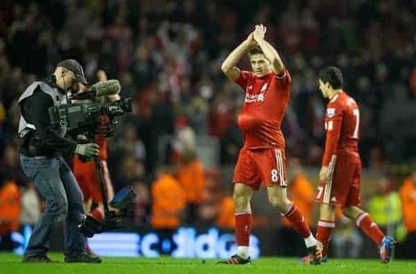 LIVERPOOL, ENGLAND - Tuesday, March 13, 2012: Liverpool's hat-trick hero captain Steven Gerrard celebrates with the match-ball tucked under his red jersey after a magnificent 3-0 thrashing of city neighbours Everton during the Premiership match at Anfield. Gerrard, on his 400th Premier League appearance, became the first player since Ian Rush in 1982 to score a hat-trick in a Merseyside Derby. (Pic by David Rawcliffe/Propaganda)