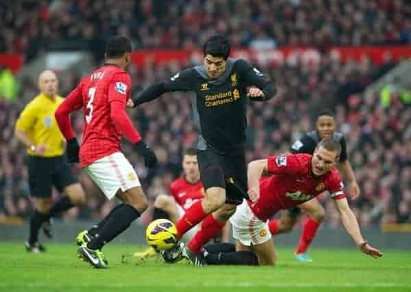 MANCHESTER, ENGLAND - Sunday, January 13, 2013: Liverpool's Luis Alberto Suarez Diaz has his shorts pulled back by Manchester United's Nemanja Vidic but no penalty was awarded by referee Howard Webb during the Premiership match at Old Trafford. (Pic by David Rawcliffe/Propaganda)