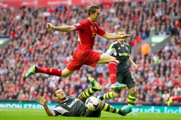 LIVERPOOL, ENGLAND - Saturday, August 17, 2013: Liverpool's Jordan Henderson and Stoke City's Erik Peters during the Premiership match at Anfield. (Pic by David Rawcliffe/Propaganda)