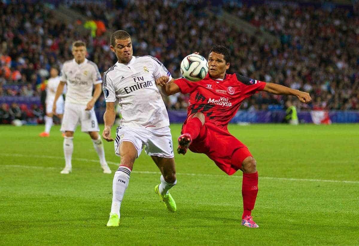 CARDIFF, WALES - Tuesday, August 12, 2014: Sevilla's Carlos Bacca in action against Real Madrid's Pepe during the UEFA Super Cup at the Cardiff City Stadium. (Pic by David Rawcliffe/Propaganda)