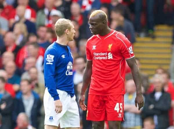 LIVERPOOL, ENGLAND - Saturday, September 27, 2014: Liverpool's Mario Balotelli clashes with Everton's Tony Hibbert during the Premier League match at Anfield. (Pic by David Rawcliffe/Propaganda)