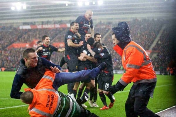 SOUTHAMPTON, ENGLAND - Sunday, February 22, 2015: A Liverpool supporter is tackled by stewards as Raheem Sterling and team-mates celebrate the second goal against Southampton during the FA Premier League match at St Mary's Stadium. (Pic by David Rawcliffe/Propaganda)