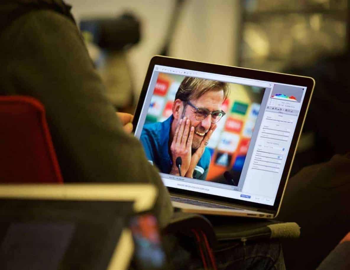 LIVERPOOL, ENGLAND - Wednesday, October 21, 2015: A photographer edits a photograph of Liverpool's manager Jürgen Klopp in Adobe Camera RAW on an Apple MacBook Pro during a press conference at Melwood Training Ground ahead of the UEFA Europa League Group Stage Group B match against FC Rubin Kazan. (Pic by David Rawcliffe/Propaganda)