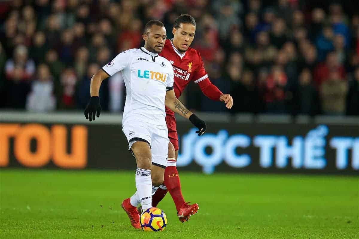 SWANSEA, WALES - Monday, January 22, 2018: Swansea City's Jordan Ayew and Liverpool's Virgil van Dijk during the FA Premier League match between Swansea City FC and Liverpool FC at the Liberty Stadium. (Pic by David Rawcliffe/Propaganda)