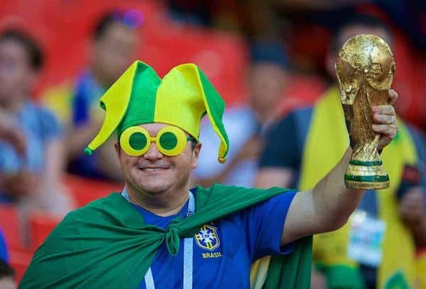 MOSCOW, RUSSIA - Wednesday, June 27, 2018: A Brazil supporter wearing novelty green and yellow sunglasses and a jester hat holds a replica World Cup trophy during the FIFA World Cup Russia 2018 Group E match between Serbia and Brazil at the Spartak Stadium. (Pic by David Rawcliffe/Propaganda)