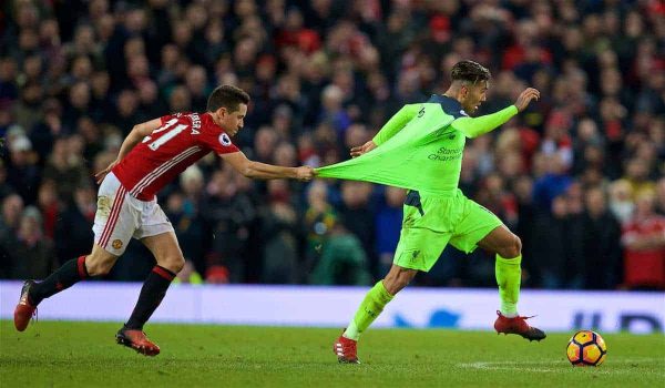 MANCHESTER, ENGLAND - Sunday, January 15, 2017: Liverpool's Roberto Firmino is held back by Manchester United's Ander Herrera during the FA Premier League match at Old Trafford. (Pic by David Rawcliffe/Propaganda)g