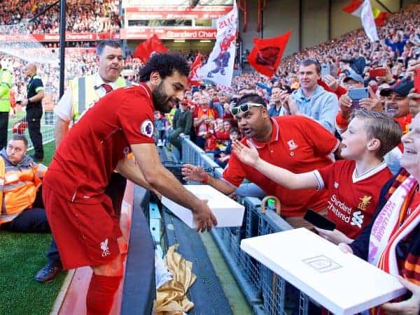 LIVERPOOL, ENGLAND - Sunday, May 13, 2018: Liverpool's Mohamed Salah receives a gift from supporters as the players perform a lap of honour after the FA Premier League match between Liverpool FC and Brighton & Hove Albion FC at Anfield. Liverpool won 4-0. (Pic by David Rawcliffe/Propaganda)