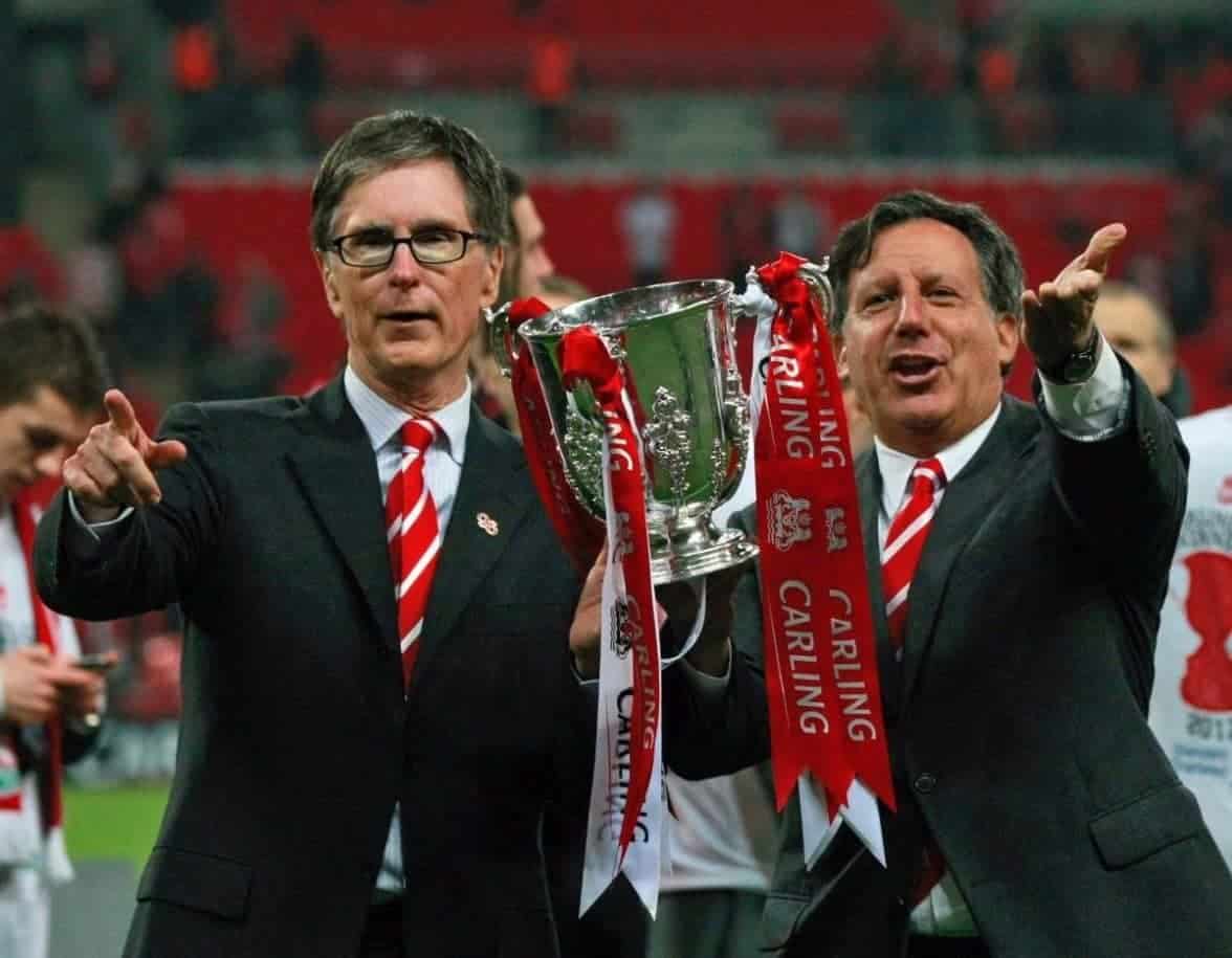 Liverpool's chairman Tom Werner, right, and owner John W. Henry, left, celebrate with the trophy after their team defeated Cardiff City, winning the English League Cup at the final soccer match at Wembley Stadium, in London, Sunday, Feb. 26, 2012. (AP Photo/Tim Hales)