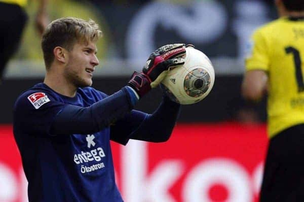 Mainz goalkeeper Loris Karius, center, holds the ball while Dortmund's Marco Reus, left, celebrates after scoring during the German first division Bundesliga soccer match between BvB Borussia Dortmund and Mainz 05 in Dortmund, Germany, Saturday, April 19, 2014. (AP Photo/Frank Augstein)