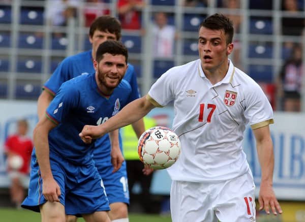 Serbia's Filip Kostic, right, challenges with Azerbaijan's Huseynov Javid, left, for the ball during a friendly soccer match between Serbia and Azerbaijan in St. Poelten, Austria, Sunday, June 7, 2015. (AP Photo/Ronald Zak)