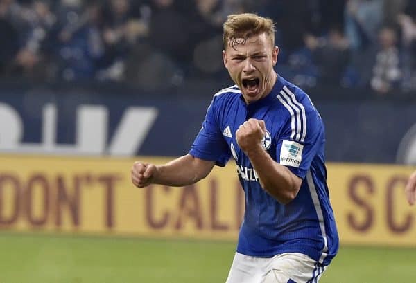 Schalke's Max Meyer, left, celebrates beside Berlin's Sebastian Langkamp after scoring the decisive goal in the very last minute of the German Bundesliga soccer match between FC Schalke 04 and Hertha BSC Berlin in Gelsenkirchen, Germany, Saturday, Oct. 17, 2015. Schalke defeated Berlin with 2-1. (AP Photo/Martin Meissner)