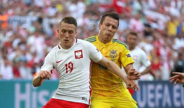 Poland's Piotr Zielinski (left) and Ukraine's Yevhen Konoplyanka battle for the ball. (Picture by: Nick Potts / EMPICS Sport)
