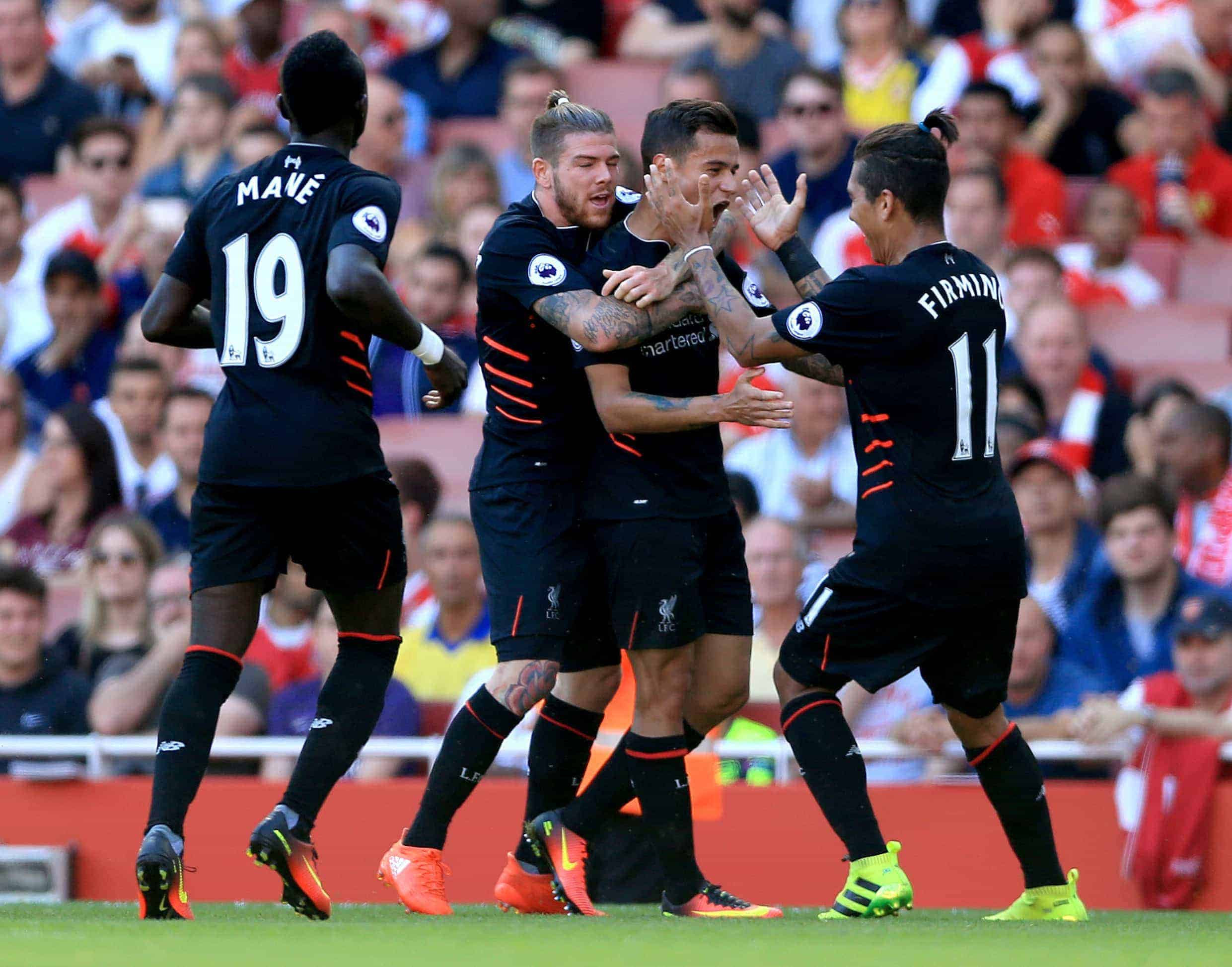 Picture by: Nigel French / EMPICS Sport Liverpool's Philippe Coutinho (second right) celebrates scoring his side's first goal of the game with team-mates