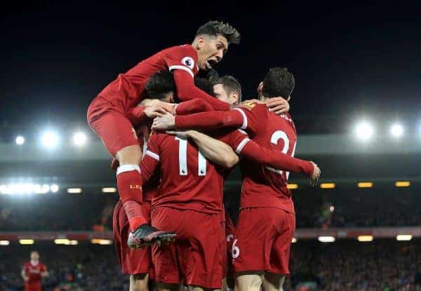 Liverpool's Mohamed Salah is mobbed by his team-mates as he celebrates scoring his side's second goal during the Premier League match at Anfield, Liverpool.