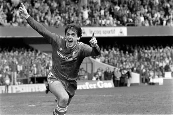 Liverpool's Kenny Dalglish celebrates after scoring the winning goal, which wrapped up the League Championship for his team