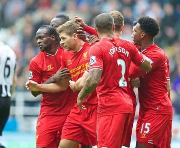 NEWCASTLE-UPON-TYNE, ENGLAND - Saturday, October 19, 2013: Liverpool's captain Steven Gerrard is mobbed by team-mates after scoring the first equalising goal against Newcastle United during the Premiership match at St. James' Park. (Pic by David Rawcliffe/Propaganda)