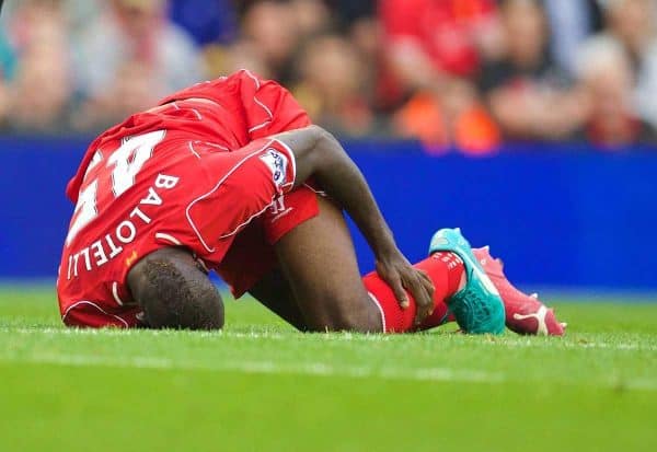 LIVERPOOL, ENGLAND - Saturday, September 13, 2014: Liverpool's Mario Balotelli goes down injured Aston Villa during the Premier League match at Anfield. (Pic by David Rawcliffe/Propaganda)