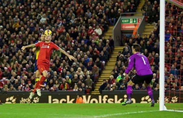 LIVERPOOL, ENGLAND - Sunday, December 21, 2014: Arsenal's Mathieu Debuchy beats Liverpool's Martin Skrtel to a header to score the first equalising goal during the Premier League match at Anfield. (Pic by David Rawcliffe/Propaganda)