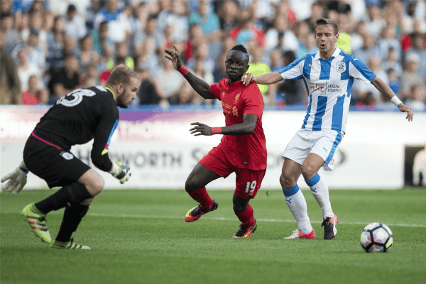 HUDDERSFIELD, ENGLAND - Wednesday, July 19, 2016: Liverpool's Sadio Mane in action against Huddersfield Town's Chris Lowe during the Shankly Trophy pre-season friendly match at the John Smith’s Stadium. (Pic by Paul Greenwood/Propaganda)