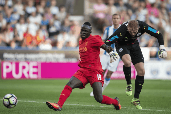 HUDDERSFIELD, ENGLAND - Wednesday, July 19, 2016: Liverpool's Sadio Mane scores his sides first goal but it is disallowed for a foul against Huddersfield Town's Joel Coleman during the Shankly Trophy pre-season friendly match at the John Smith’s Stadium. (Pic by Paul Greenwood/Propaganda)