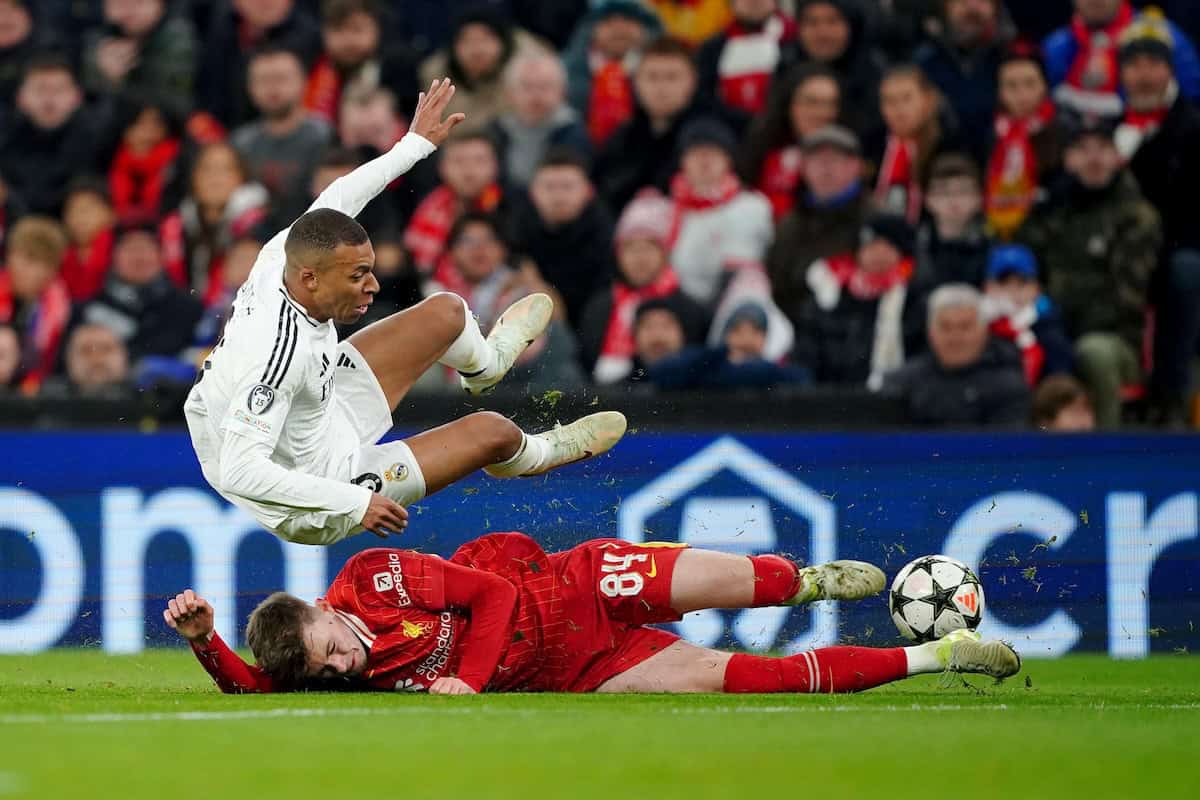 2YP00AX Liverpool's Conor Bradley (bottom) tackles Real Madrid's Kylian Mbappe during the UEFA Champions League, league stage match at Anfield, Liverpool. Picture date: Wednesday November 27, 2024. (PA Images / Alamy Stock Photo)