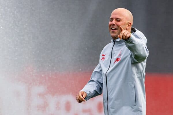 LIVERPOOL, ENGLAND - Tuesday, October 1, 2024: Liverpool's head coach Arne Slot laughs after being caught by the sprinklers during a training session at the AXA Training Centre ahead of the UEFA Champions League match between Liverpool FC and Bologna FC. (Photo by David Rawcliffe/Propaganda)