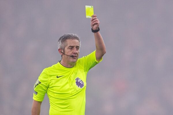 LIVERPOOL, ENGLAND - Saturday, December 14, 2024: Referee Darren Bond shows a yellow card during the FA Premier League match between Liverpool FC and Fulham FC at Anfield. (Photo by David Rawcliffe/Propaganda)