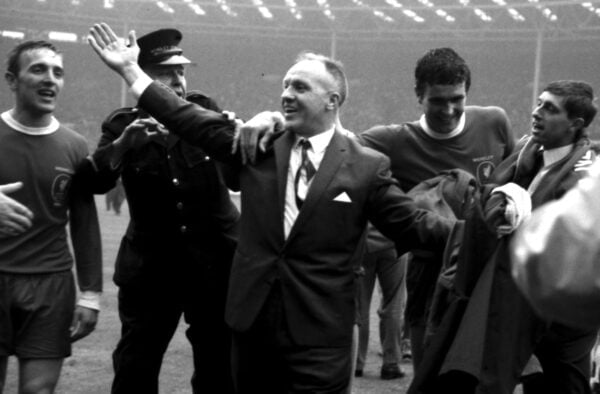 Liverpool manager Bill Shankly (c) celebrates victory as he leaves the pitch with Peter Thompson (l) and Ron Yeats (r) after the match